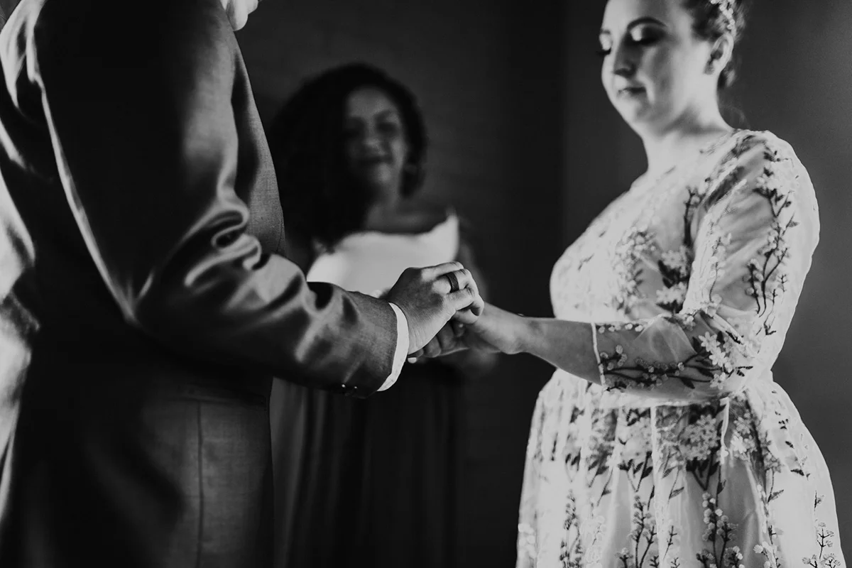 queer surprise home wedding andi and jess holding hands during ceremony