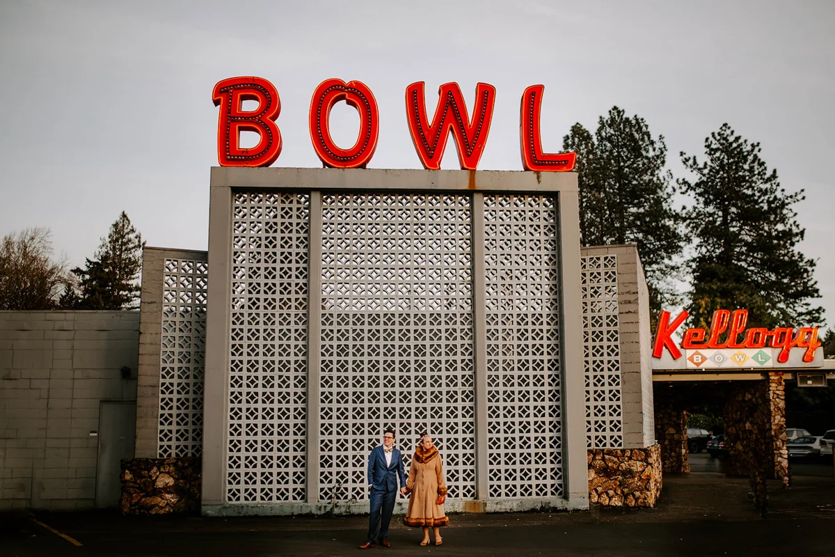 queer surprise home wedding andi and jess outside bowling alley sign