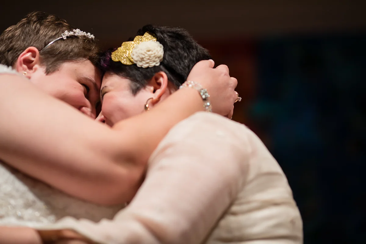 two brides embraced and touching noses right after exchanging vows at their wedding ceremony Meera Graham Photography Missoula Montana