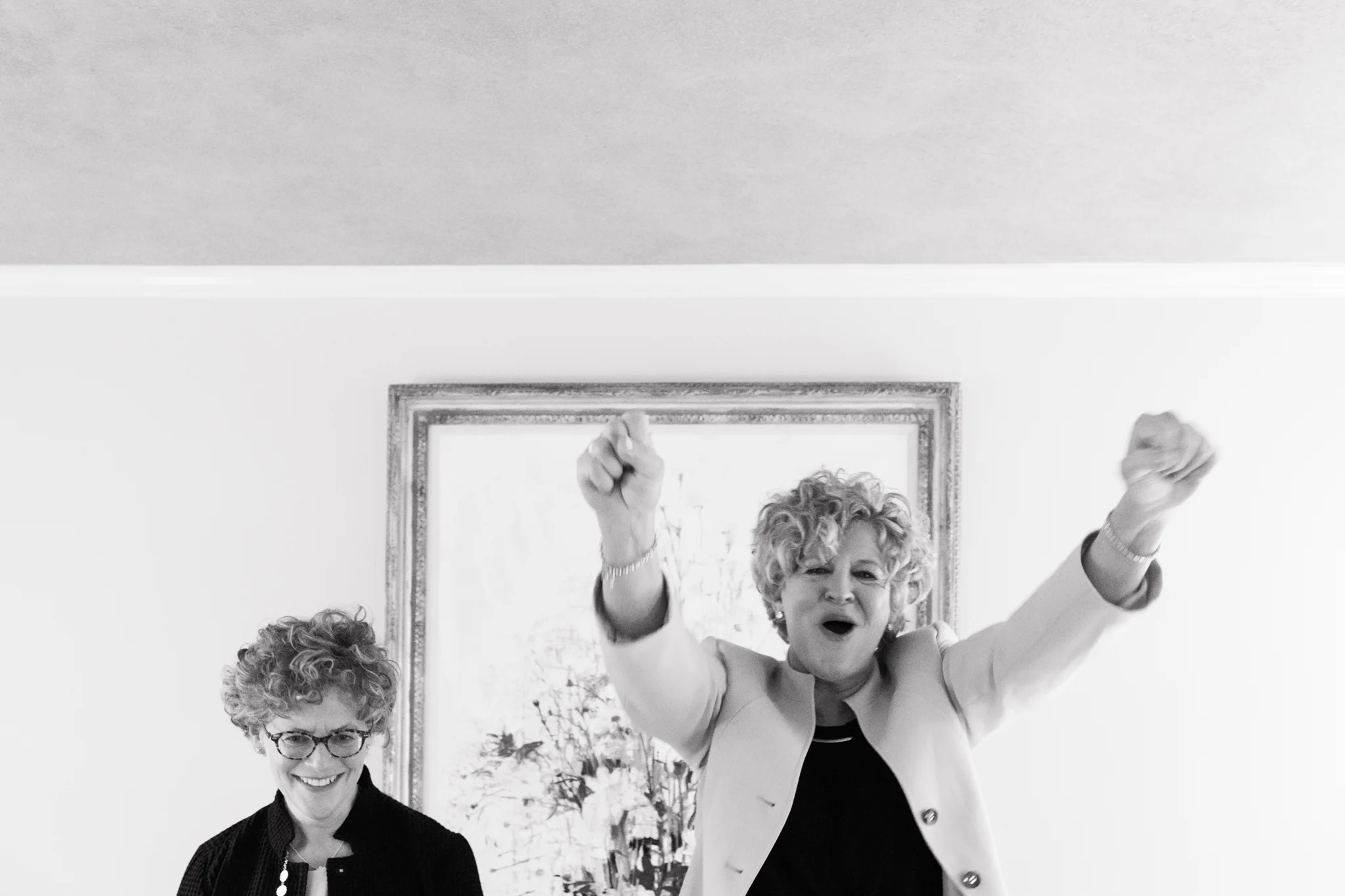 two brides excited and raising arms up in the air after exchanging their vows at their casual wedding Meera Graham Photography Missoula Montana