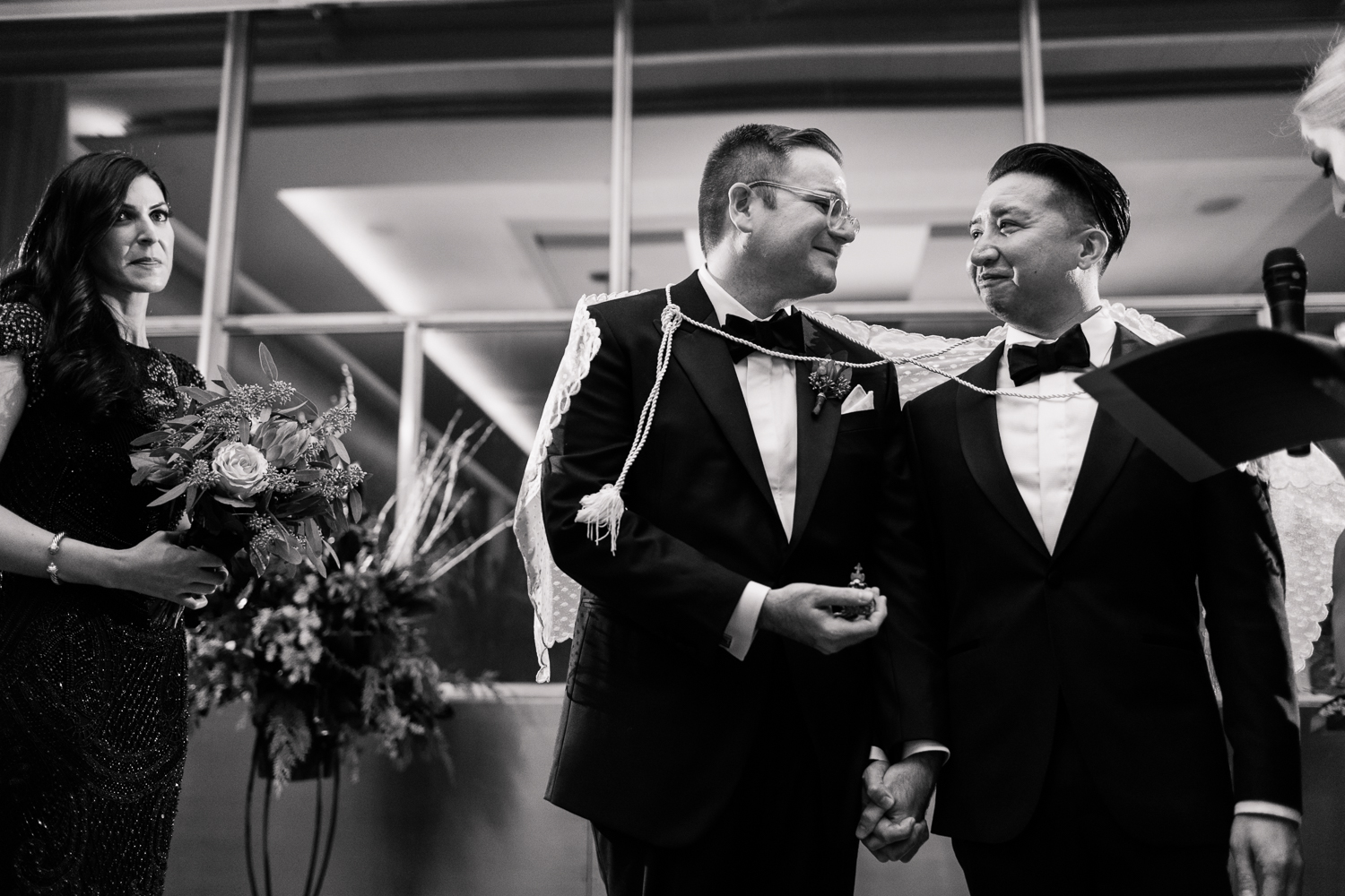 two grooms bound together and exchanging vows while holding hands during their wedding ceremony Meera Graham Photography Missoula Montana