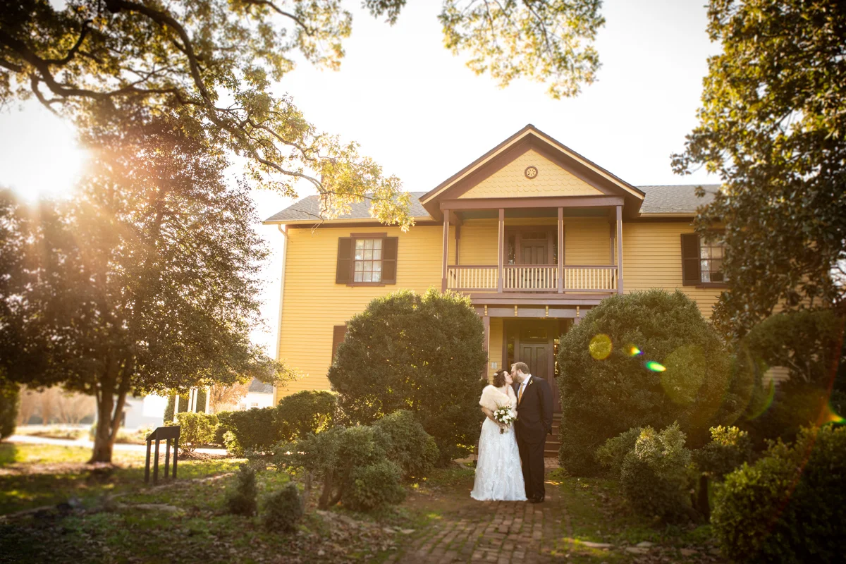 Romantic, Intimate-Feeling Wedding kiss in front of house