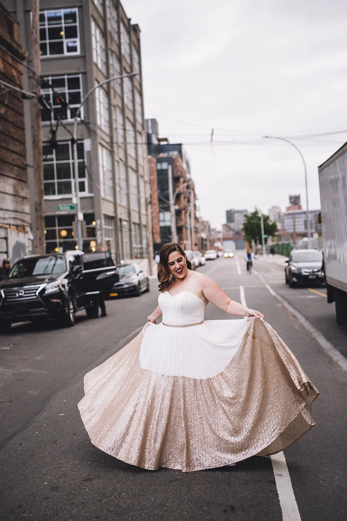 bride standing in the middle of a nyc street showing off her pink glitter wedding dress