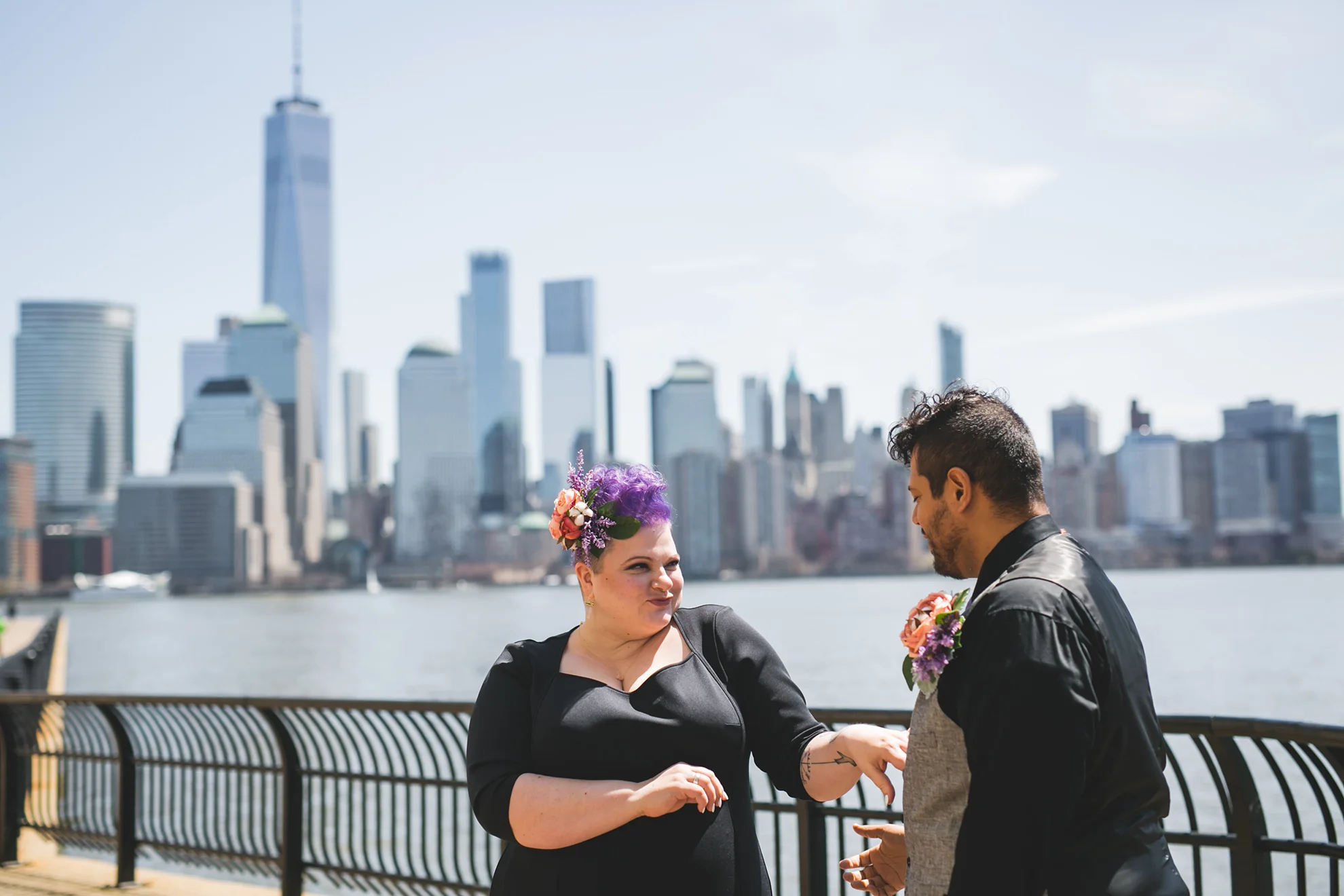 couple in all black smiling at their elopement in DUMBO NYC