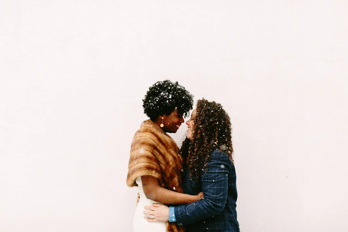 wes anderson inspired wedding brooklyn new york couple embrace as snow falls