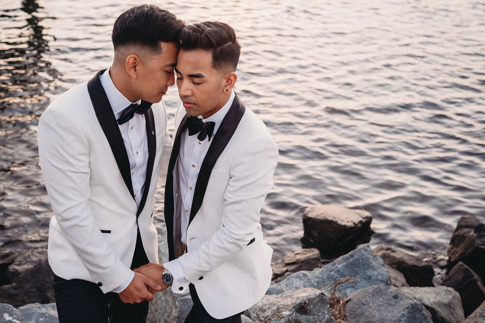 two grooms in matching suits embrace by water lgbtq los angeles photographer rebecca y las otras