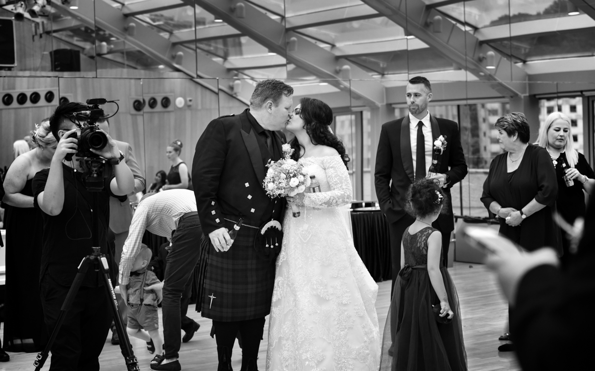 Mita and James sharing a kiss at their western wedding ceremony in hong kong