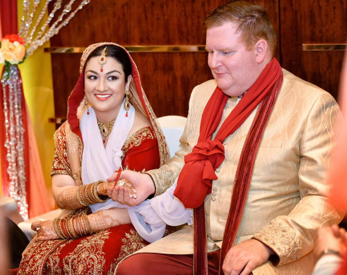 Mita and James holding hands as part of their Indian wedding ceremony in hong kong