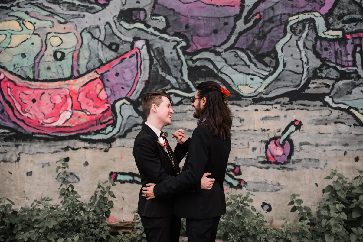 intimate wedding richmond virginia couple dancing in front of wall mural