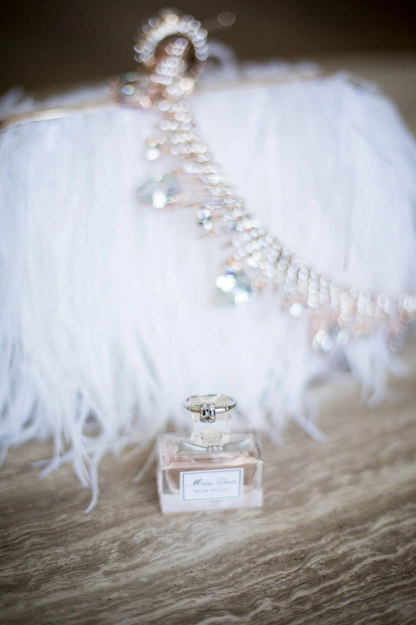 perfume and crystal crown draped over fur fringe clutch before wedding los angeles california crystal lily photography