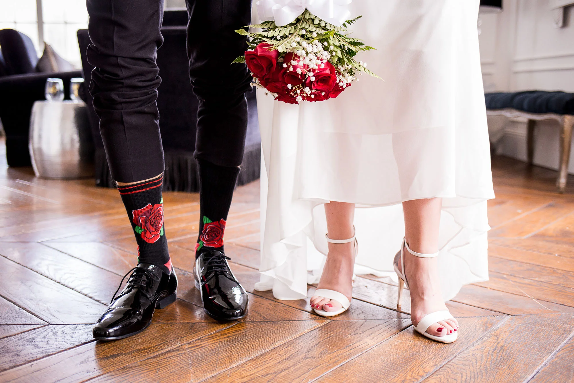 couple showing off there wedding shoes and grooms red rose high socks los angeles california crystal lily photography