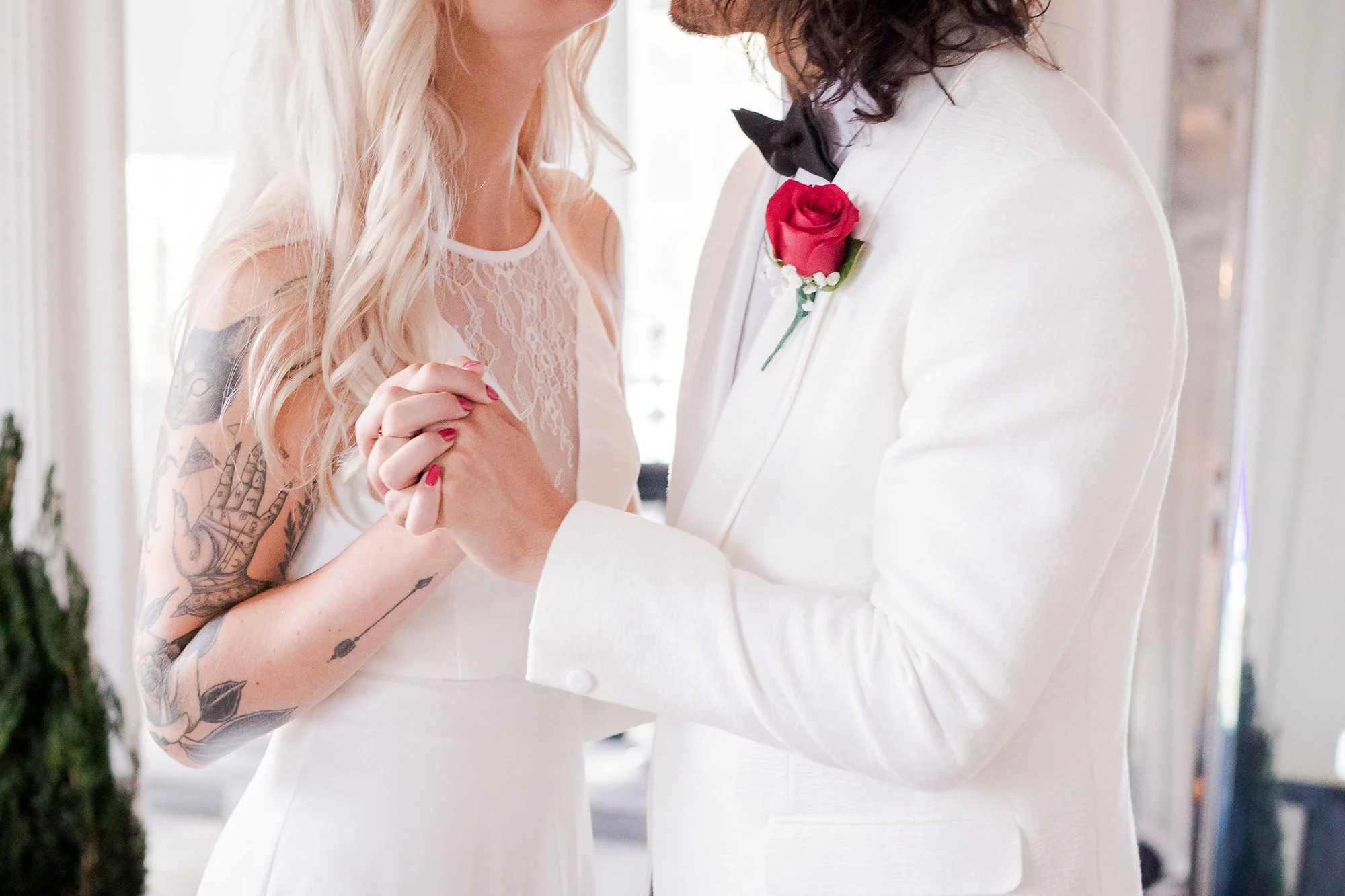 tattooed bring and groom holding hands and dancing after their wedding los angeles california crystal lily photography