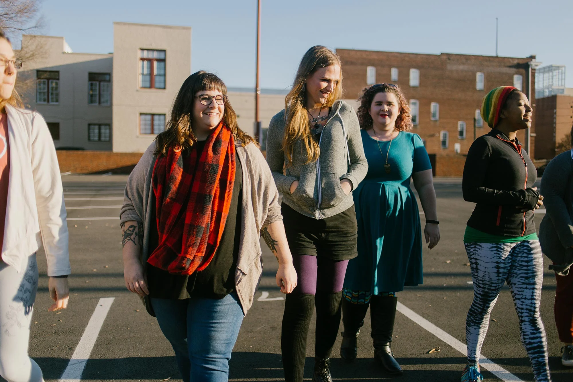 group of friends walk together through parking lot at sunset richmond virginia hidden exposure photography