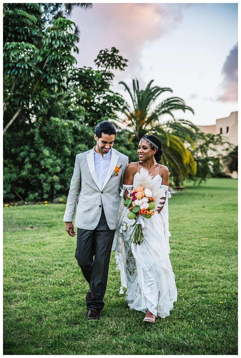 Newlywed couple walks along with tropical palm trees behind Sharma Shari Florida Wedding Photographer