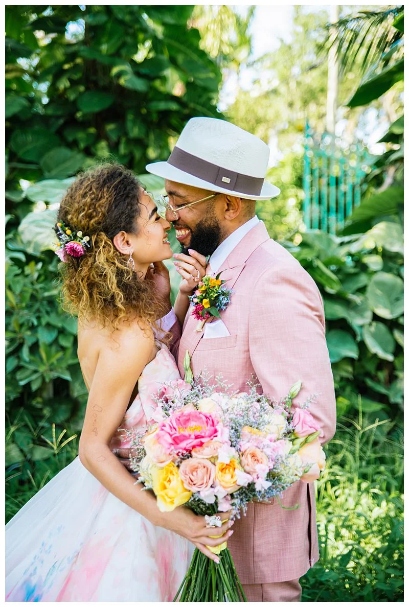 bride and groom in pink suit about to share a kiss at tropical wedding Sharma Shari Puerto Rican Wedding Photography