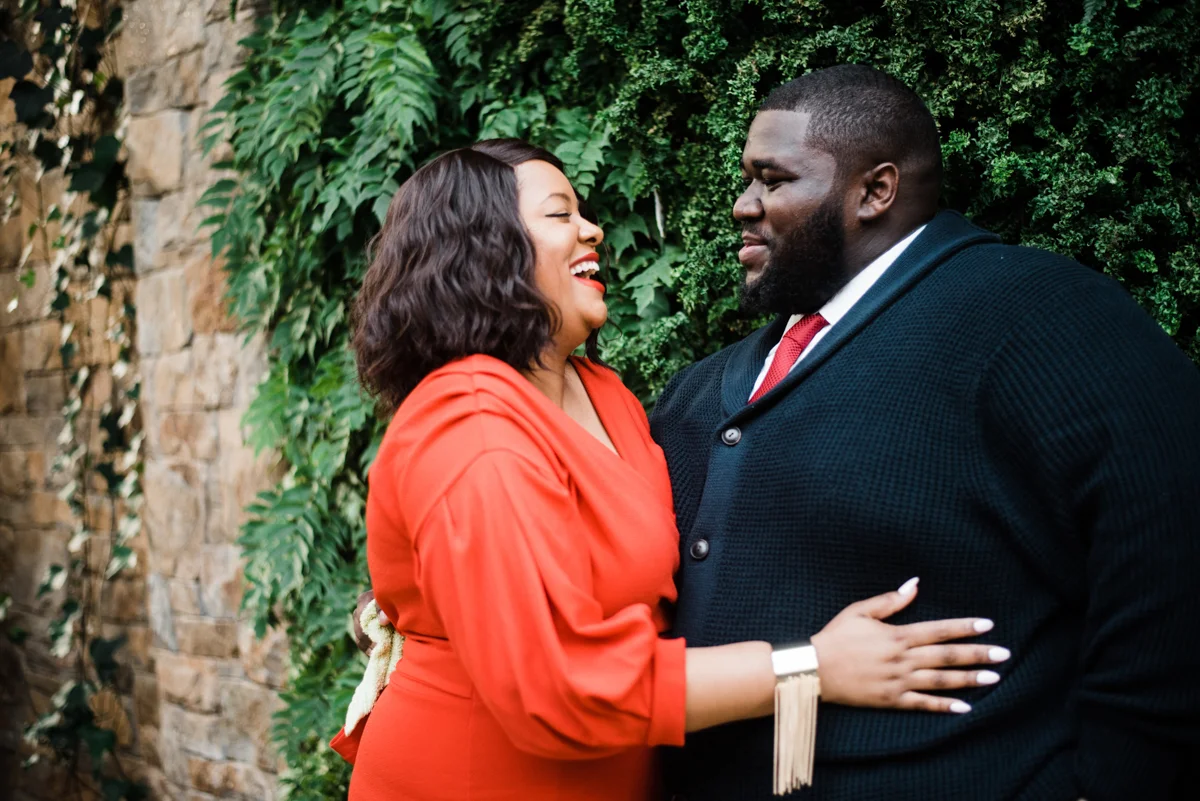 longwood gardens engagement kennett square pennsylvania sgw photography angelo and yasmine by brick wall with foliage