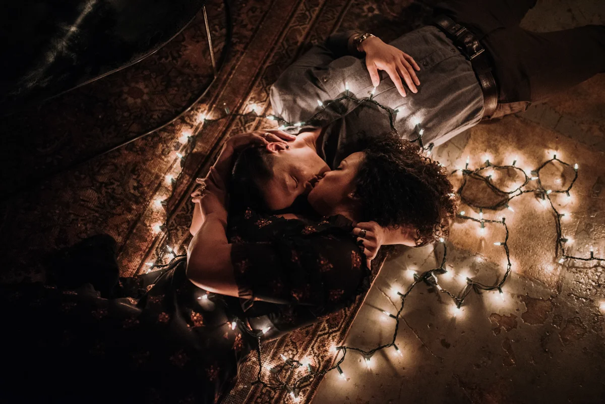 surprise proposal wm. mulherin’s sons hotel philadelphia pennsylvania lauren driscoll photography kiss laying on floor surrounded by string lights