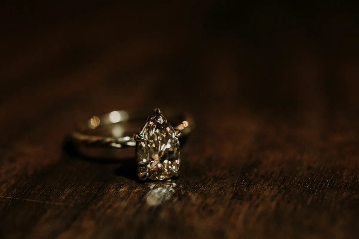 surprise proposal wm. mulherin’s sons hotel philadelphia pennsylvania lauren driscoll photography teardrop-shaped ring on table