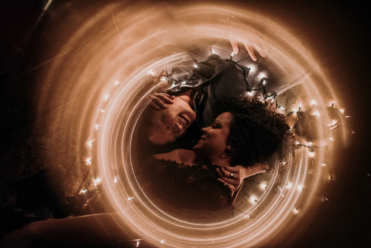 surprise proposal wm. mulherin’s sons hotel philadelphia pennsylvania lauren driscoll photography couple laying on floor with blurred light effect