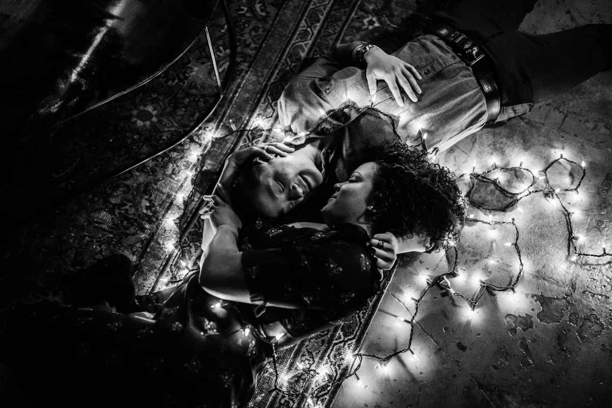 surprise proposal wm. mulherin’s sons hotel philadelphia pennsylvania lauren driscoll photography couple on floor with string lights, black and white