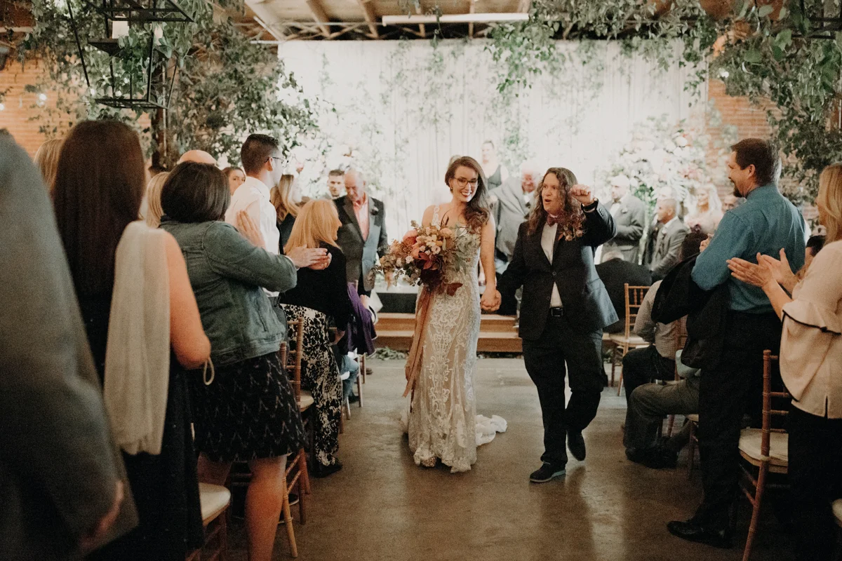 ABBY AND NICK WEDDING AMARILLO TX RITTER COLLECTIVE PHOTOGRAPHY COUPLE WALKING UP AISLE