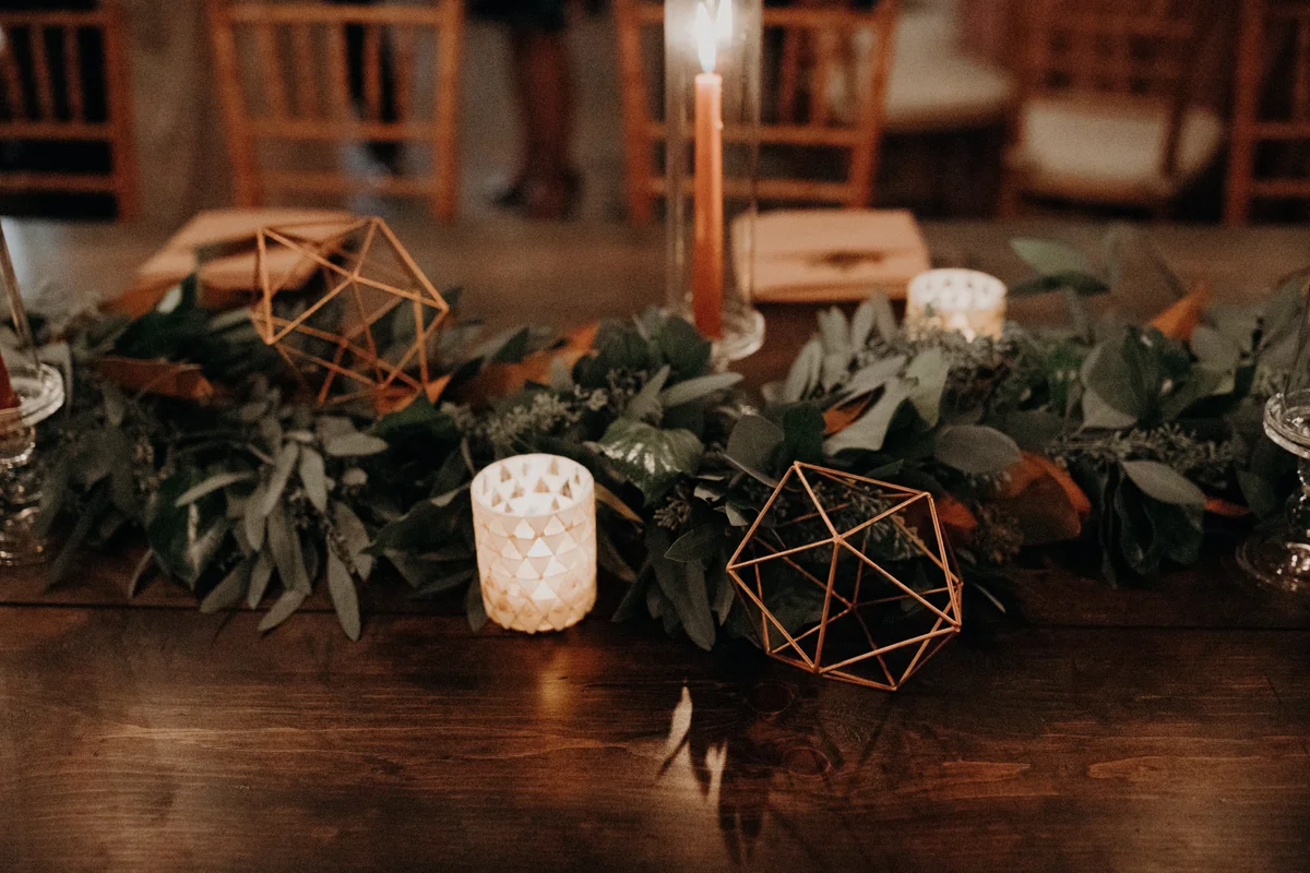 ABBY AND NICK WEDDING AMARILLO TX RITTER COLLECTIVE PHOTOGRAPHY BAR WITH GREENERY RUNNER, GEOMETRIC SHAPES, AND CANDLES