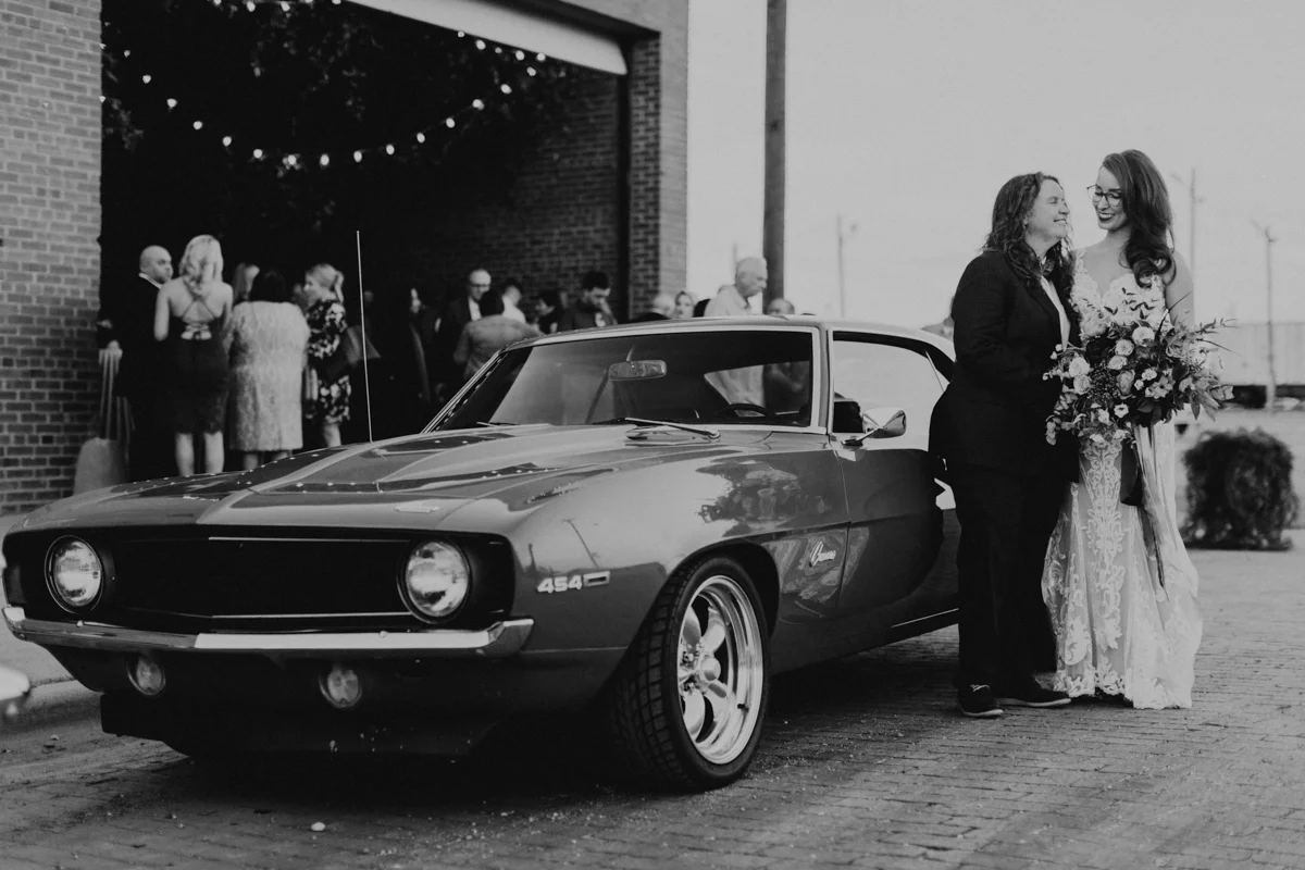 ABBY AND NICK WEDDING AMARILLO TX RITTER COLLECTIVE PHOTOGRAPHY COUPLE BESIDE CAMARO OUTSIDE VENUE