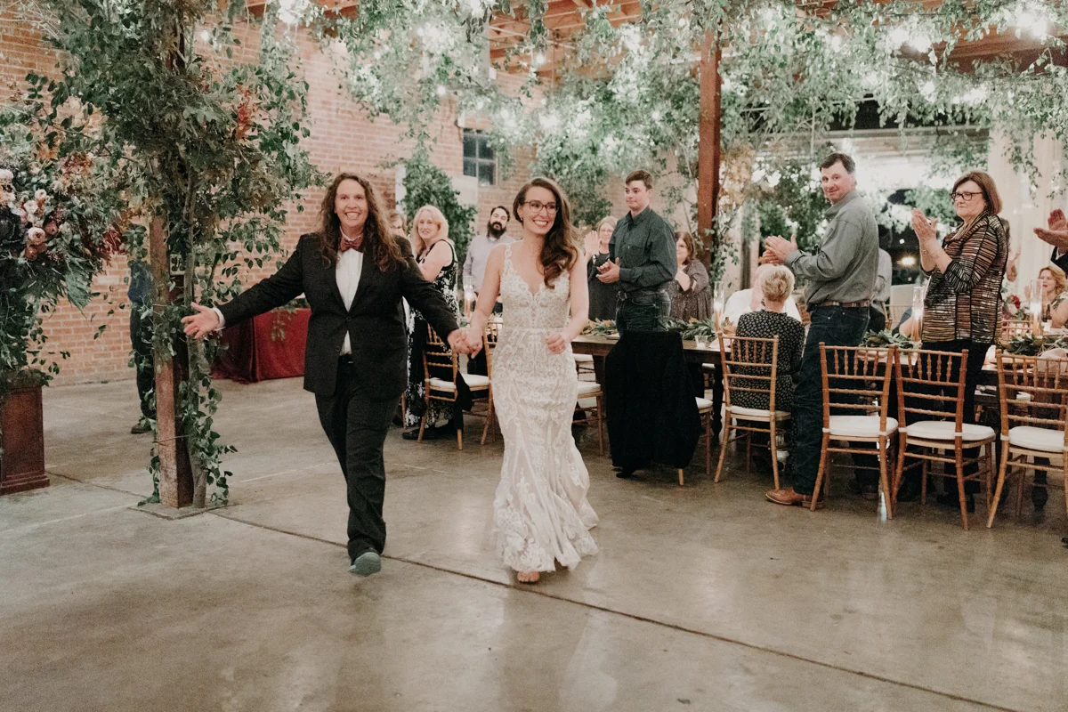 ABBY AND NICK WEDDING AMARILLO TX RITTER COLLECTIVE PHOTOGRAPHY GUESTS CLAPPING AS BRIDES GO TO DANCE FLOOR