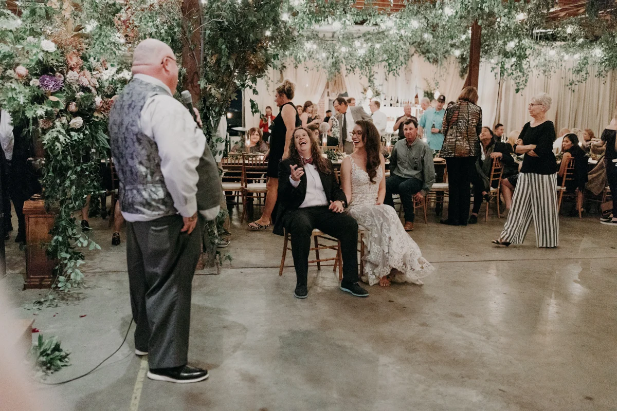 ABBY AND NICK WEDDING AMARILLO TX RITTER COLLECTIVE PHOTOGRAPHY BRIDES LAUGHING DURING SPEECH