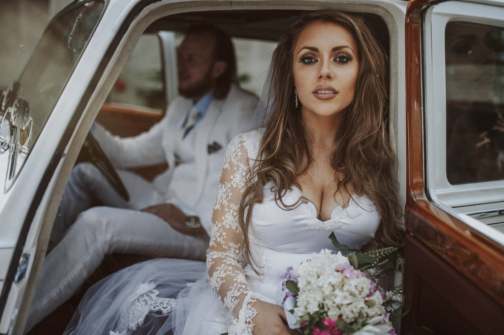 bride and groom arrive in vintage car wearing DIY wedding dress serbia Aleska and Mina Photography