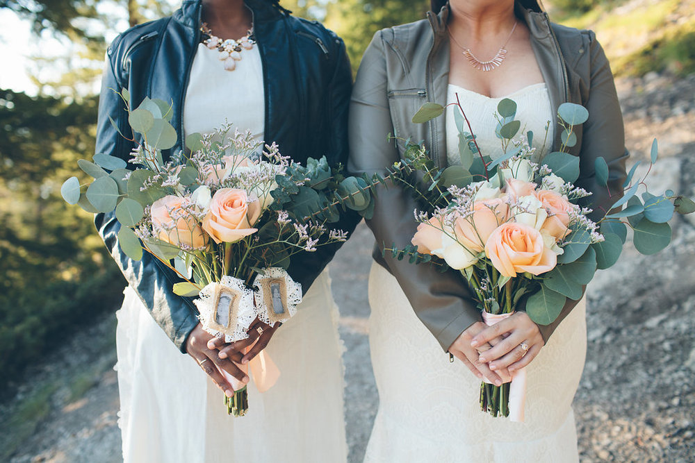 brides in DIY wedding dresses and leather jackets while holding DIY bouquets at Colorado wedding Cassandra Zetta Photography