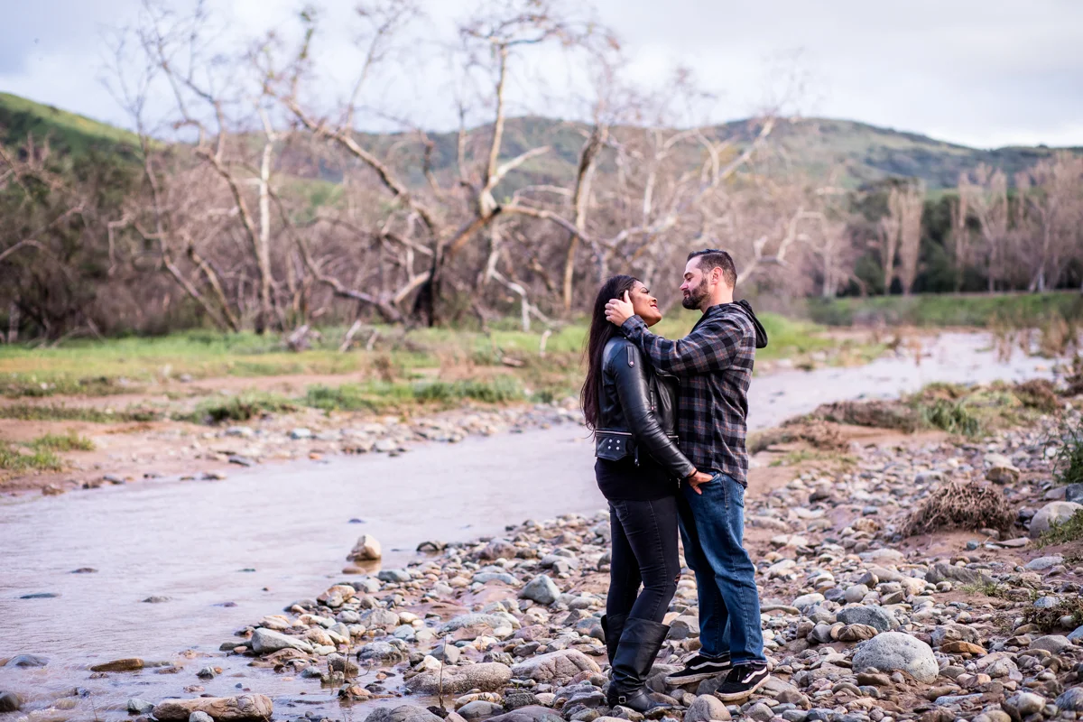 irvine regional park engagement session crystal lilly photography embrace next to rocky stream