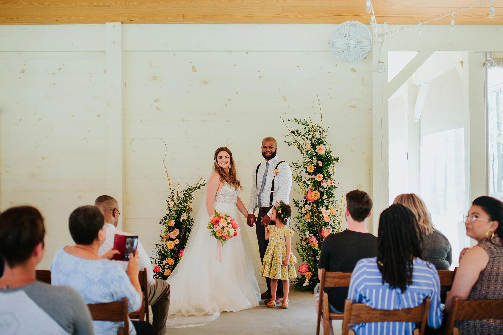 Lush wedding inspiration at Seven Springs VA with bride and groom and daughter during ceremony Carly Romeo & Co.