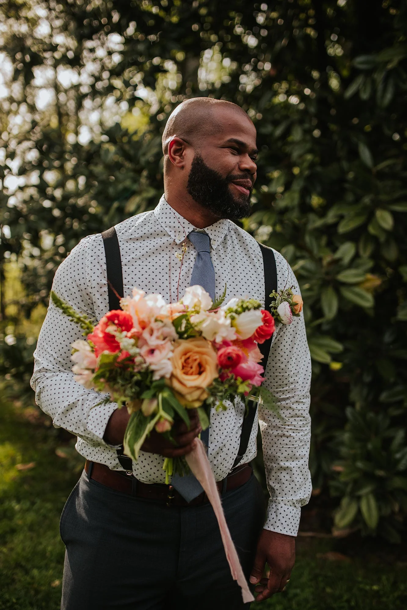 Lush wedding inspiration at Seven Springs VA with groom smiling and holding bouquet Carly Romeo & Co.