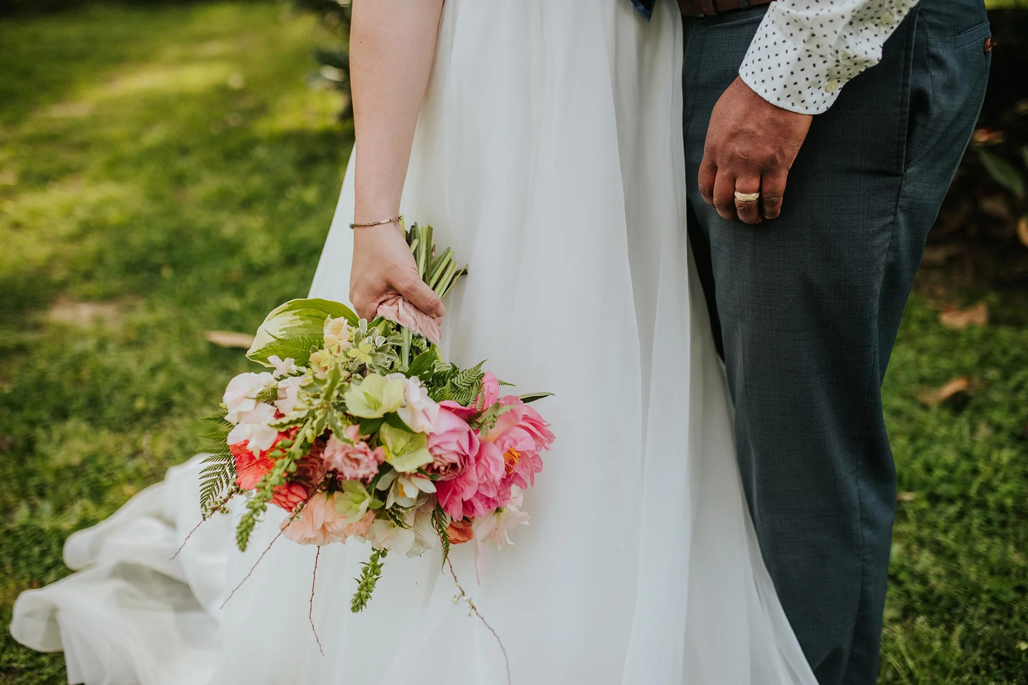 Lush wedding inspiration at Seven Springs VA with bride and groom embraced in garden Carly Romeo & Co.