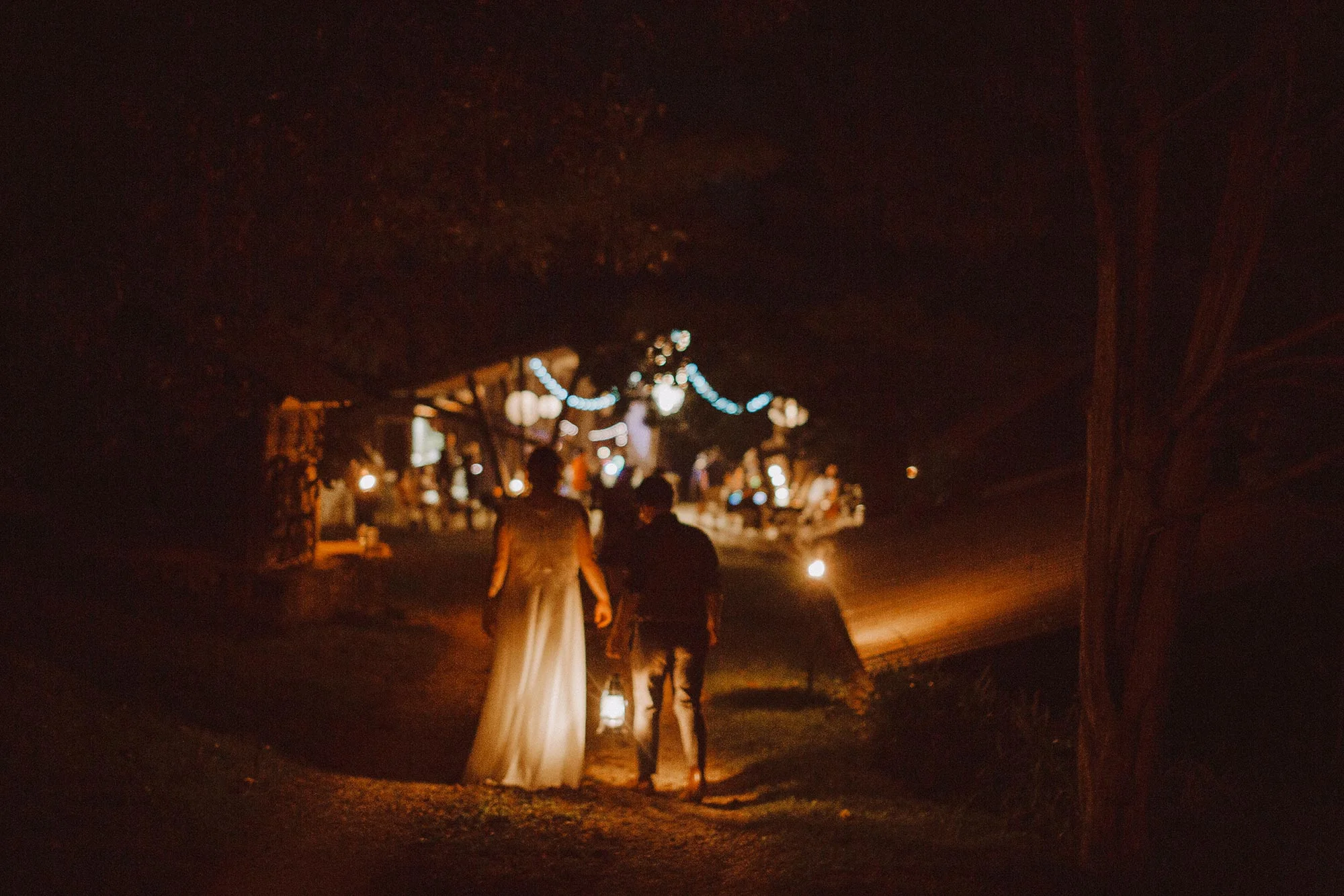 DIY summer camp wedding spring green wisconsin heidi uhlman photography alex and frances walking with lantern