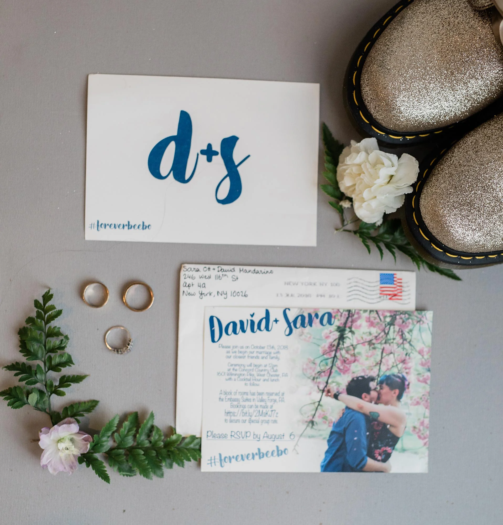 Chic Queer Wedding in West Chester Pennsylvania showing wedding rings and invitations Judson Rappaport Photography