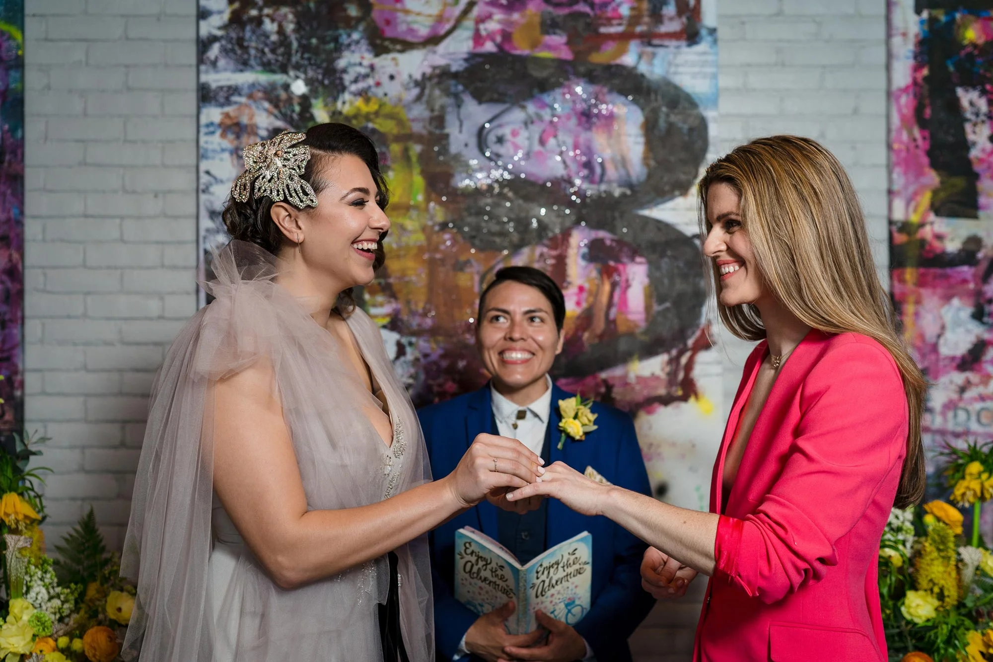 Bright Neon Wedding Inspiration at The Bowery Hotel NYC showing couple exchanging rings JC Lemon Photography