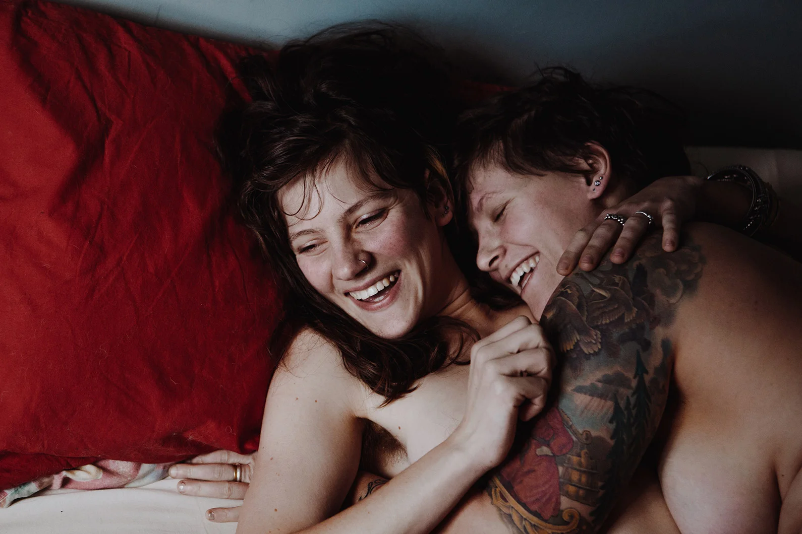 Two women smiling and embracing intimately in a Couples Boudoir Session Robyn Nicole Film + Photo Portland Maine