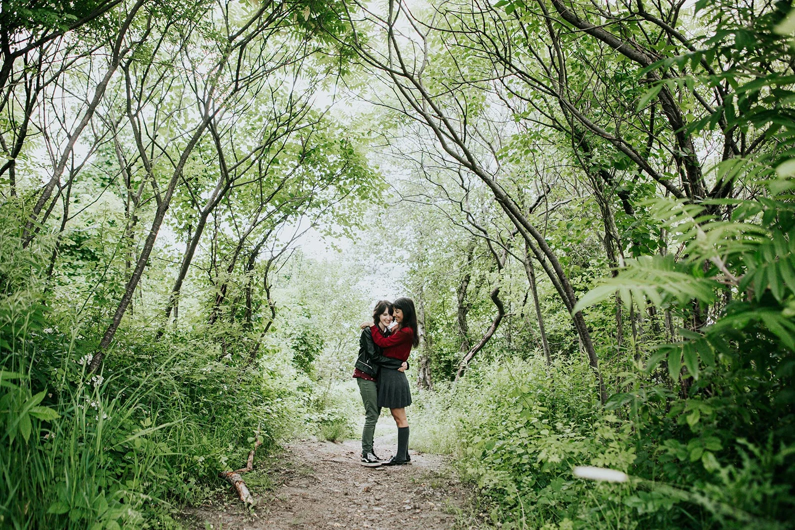 Engaged couple embracing in a forest Robyn Nicole Film + Photo Portland Maine