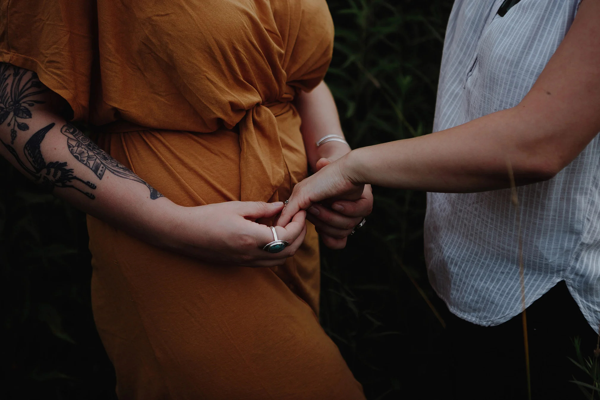 Engaged couple sliding on their engagement ring Robyn Nicole Film + Photo Portland Maine