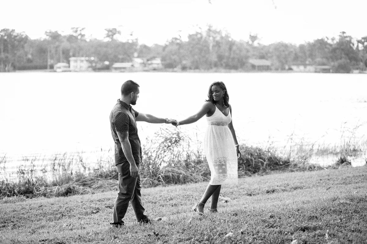 CYPRESS GROVE ENGAGEMENT SESSION CRYSTAL LILY PHOTOGRAPHY COUPLE HOLDING HANDS WALKING BY LAKE