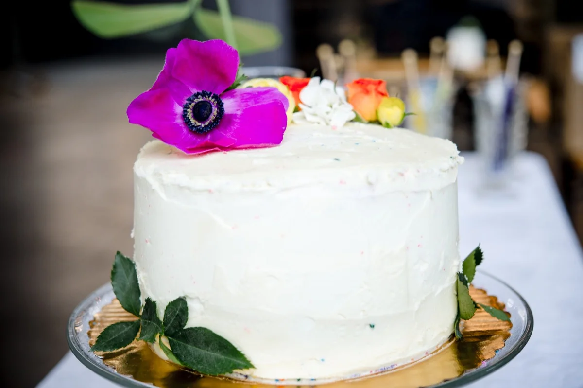 RAINBOW QUEER WEDDING INSPIRATION MICHELLE SCHAPIRO, DEANNA NAGLE, cake decorated with flowers