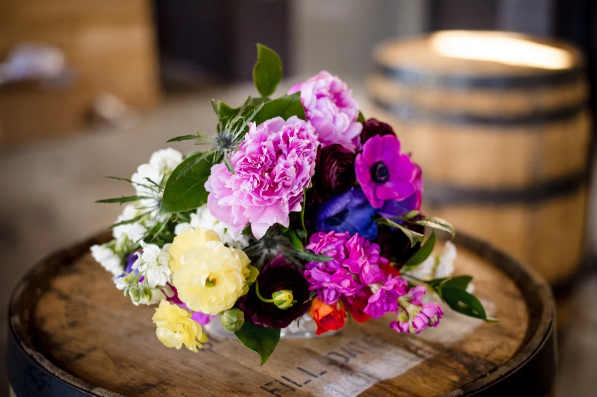 RAINBOW QUEER WEDDING INSPIRATION MICHELLE SCHAPIRO, DEANNA NAGLE, bouquet on barrel