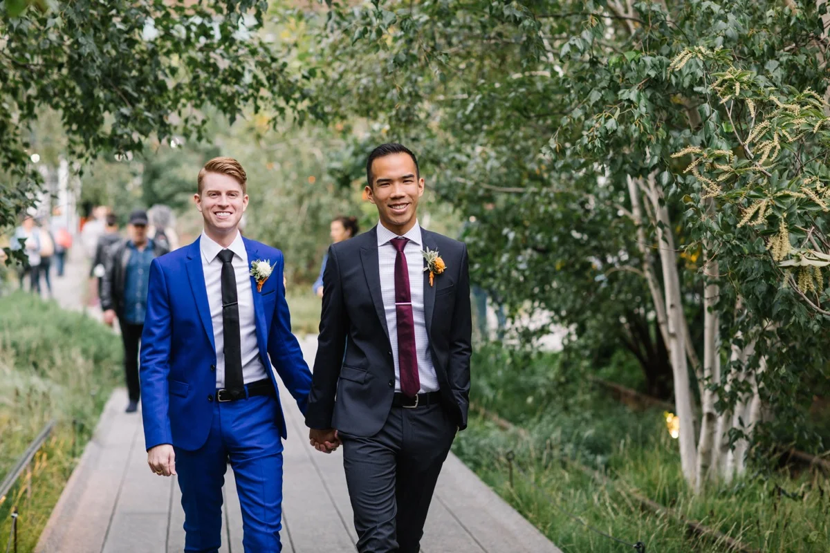 modern mediterranean wedding meatpacking district new york city rima brindamour photography alex and michael holding hands walking down path