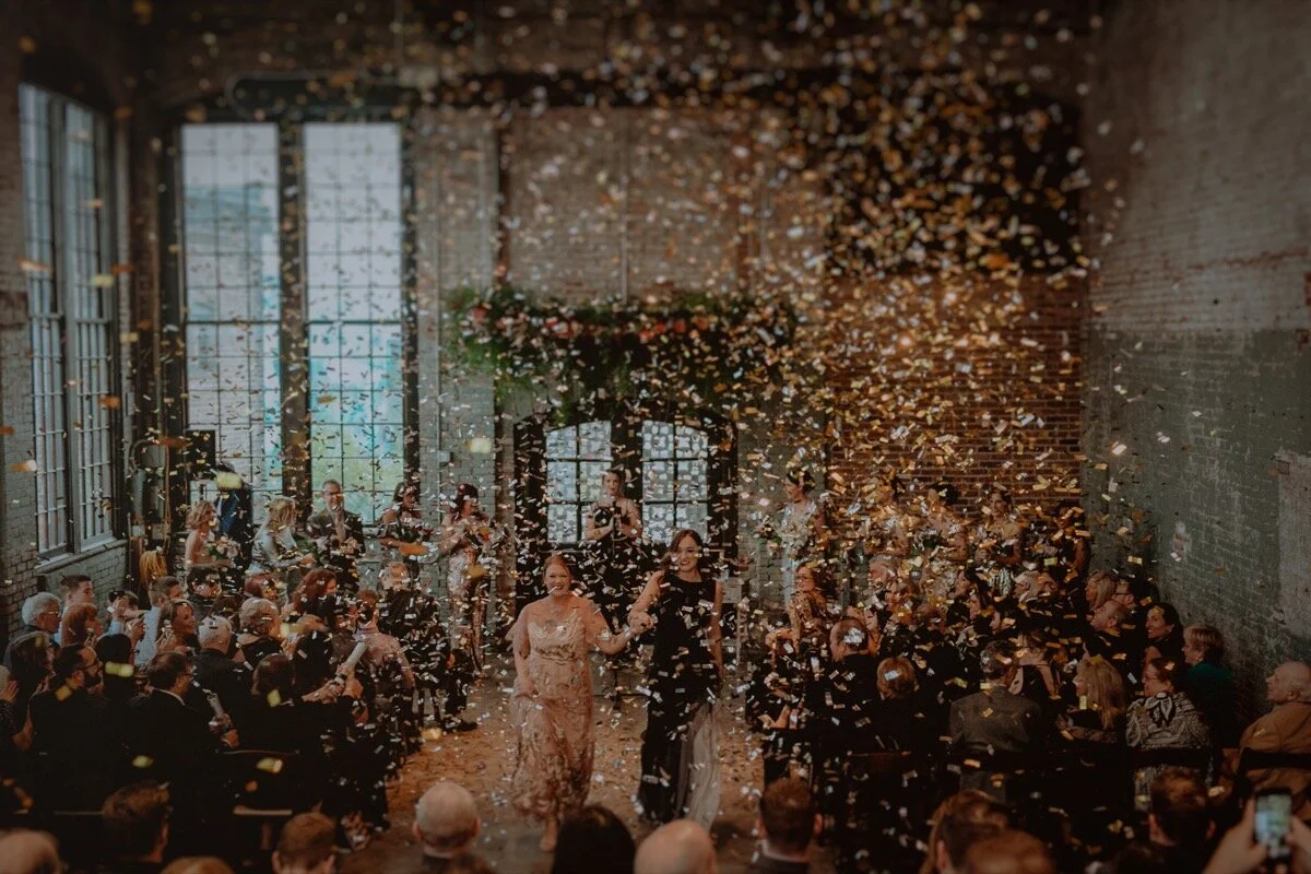 Confetti in air during ceremony recessional at industrial wedding venue in Hudson New York Chellise Michael Photography