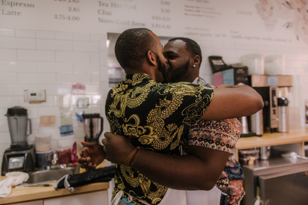 Chris and Nate kiss after surprise proposal at sugar bakeshop denver colorado Friends and Lovers Photography