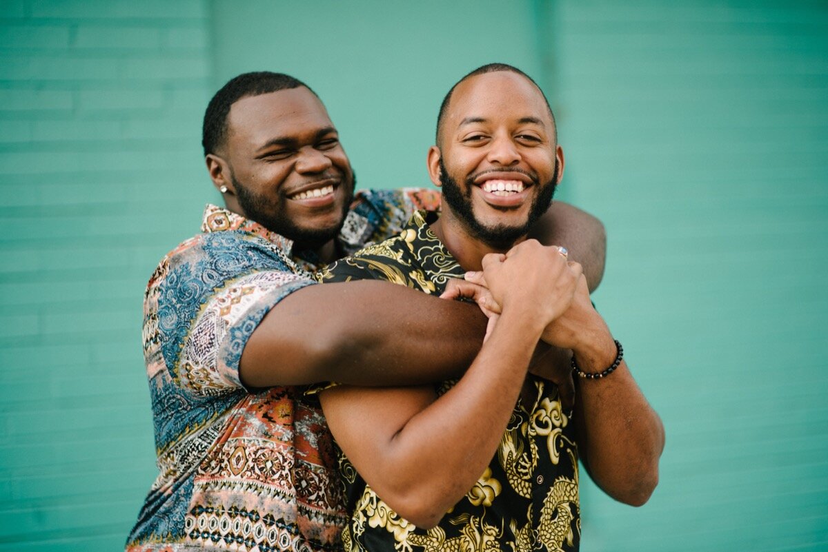 Chris and Nate embrace after surprise proposal at sugar bakeshop denver colorado Friends and Lovers Photography
