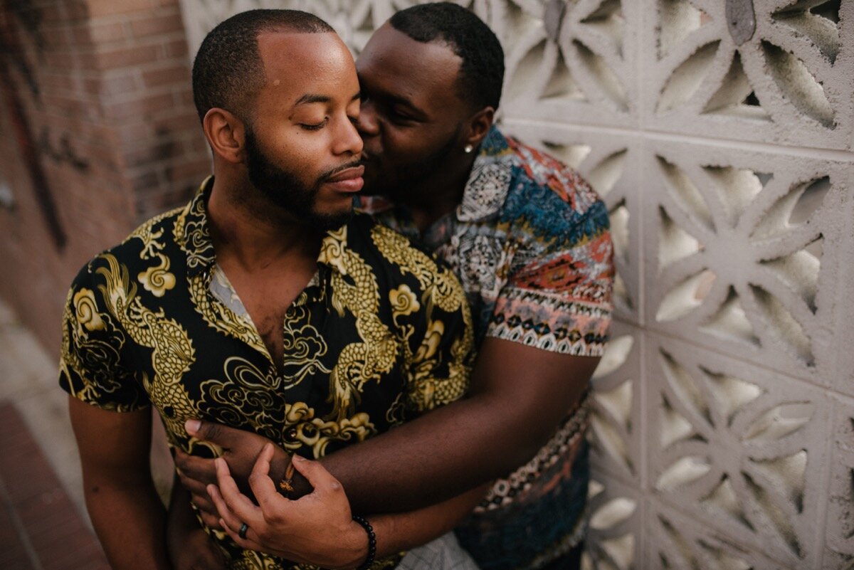 Chris and Nate kiss on cheek after surprise proposal at sugar bakeshop denver colorado Friends and Lovers Photography