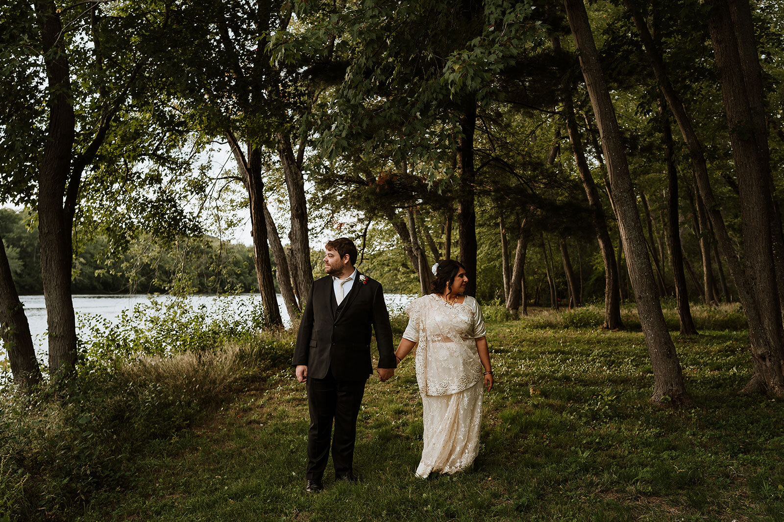 Newlywed couple hold hands under trees Rachel Epperly Film and Photo Portland Oregon